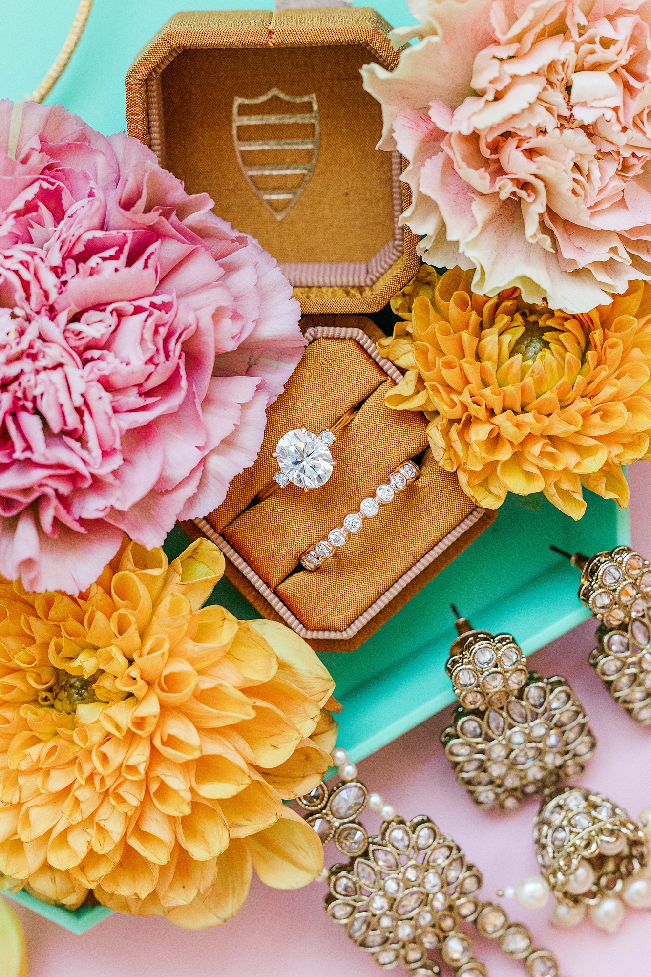 Detail photo of colorful stationery, bold florals and textured linens from the multi-day celebration