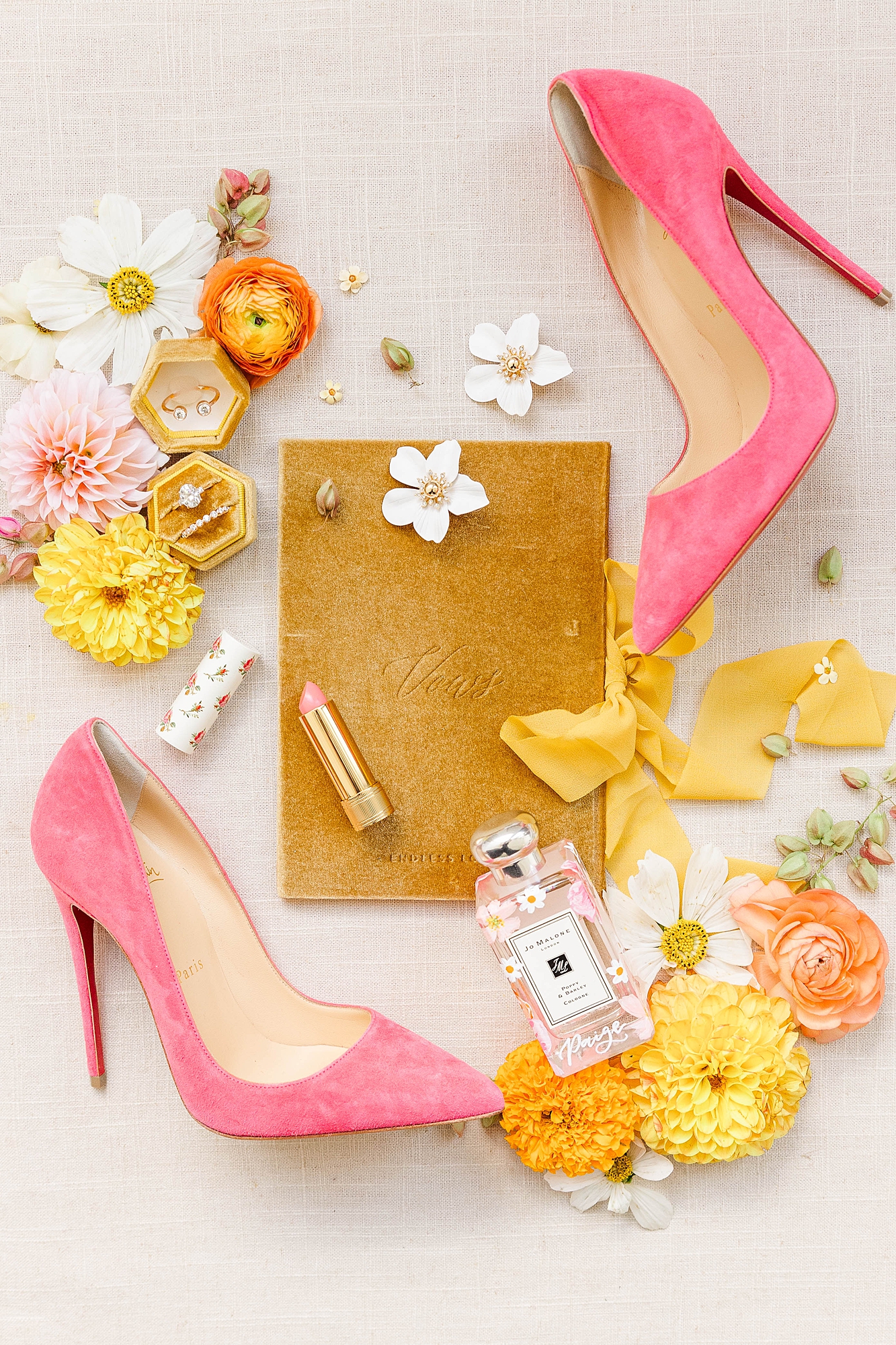 Detail photo of colorful stationery, bold florals and textured linens from the multi-day celebration