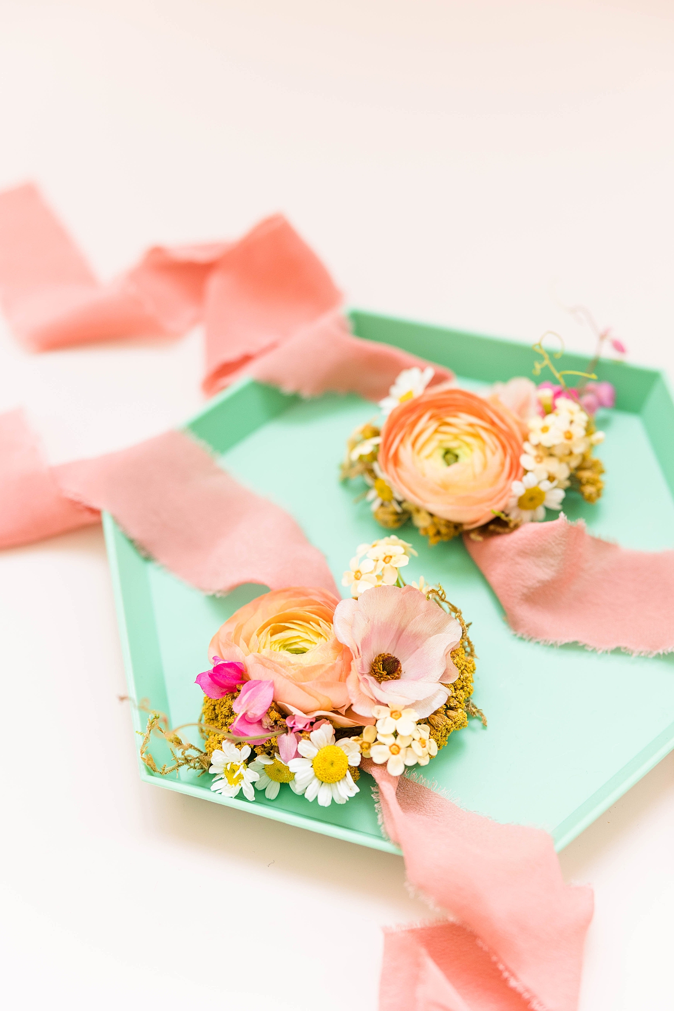 Detail photo of colorful stationery, bold florals and textured linens from the multi-day celebration