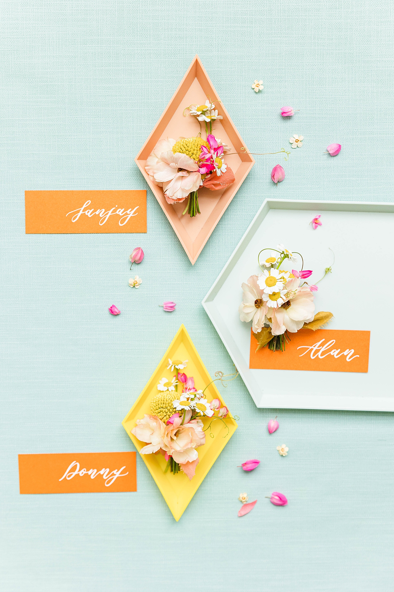 Detail photo of colorful stationery, bold florals and textured linens from the multi-day celebration