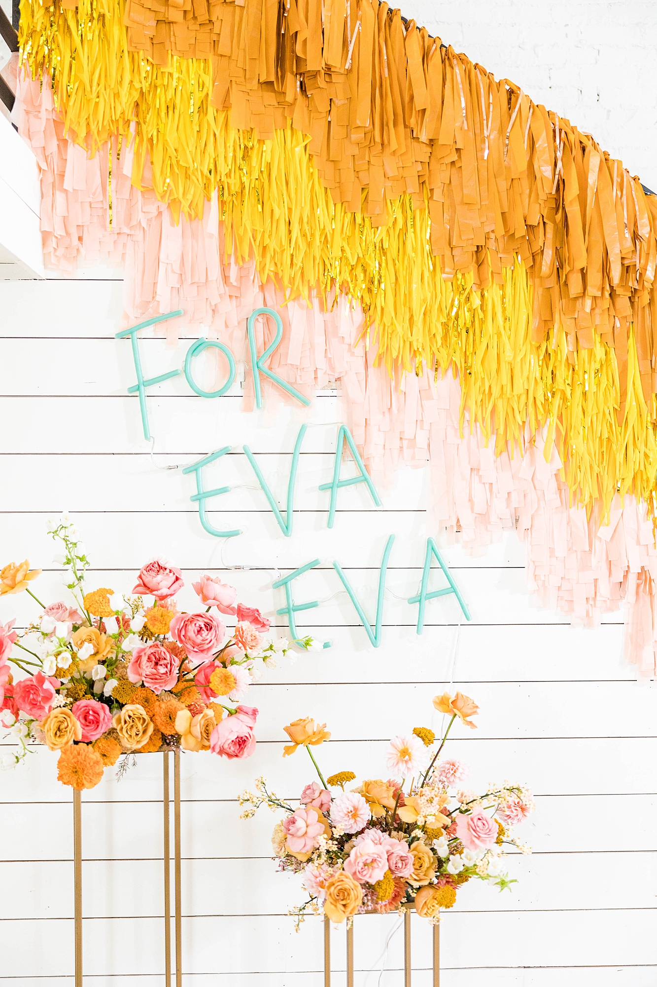 Western reception with retro-inspired decor in peach, mustard, teal and orange, guests dancing under fall light