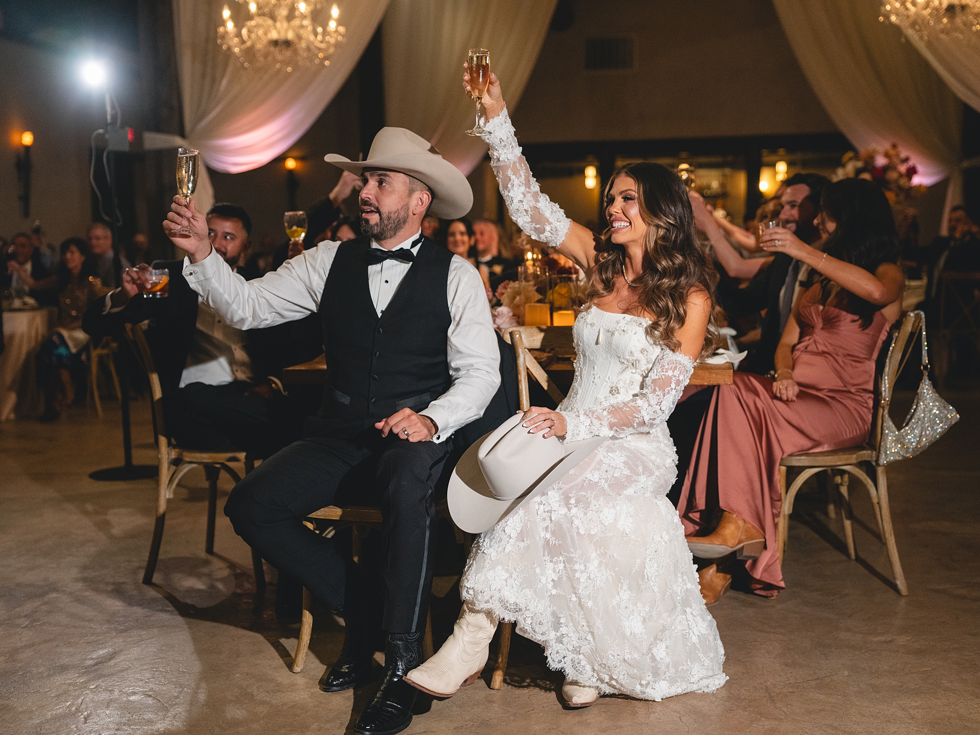 toasts and guests celebrating in the warm evening light at San Antonio reception by Paige Vaughn Photo