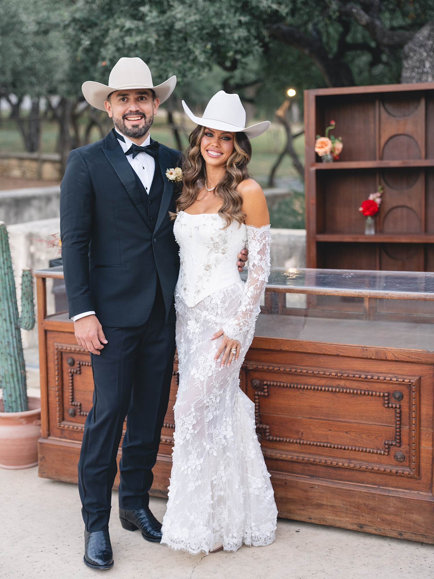 Reception tablescape with lush florals, elegant linens, and candlelight at San Antonio wedding bride and groom portrait