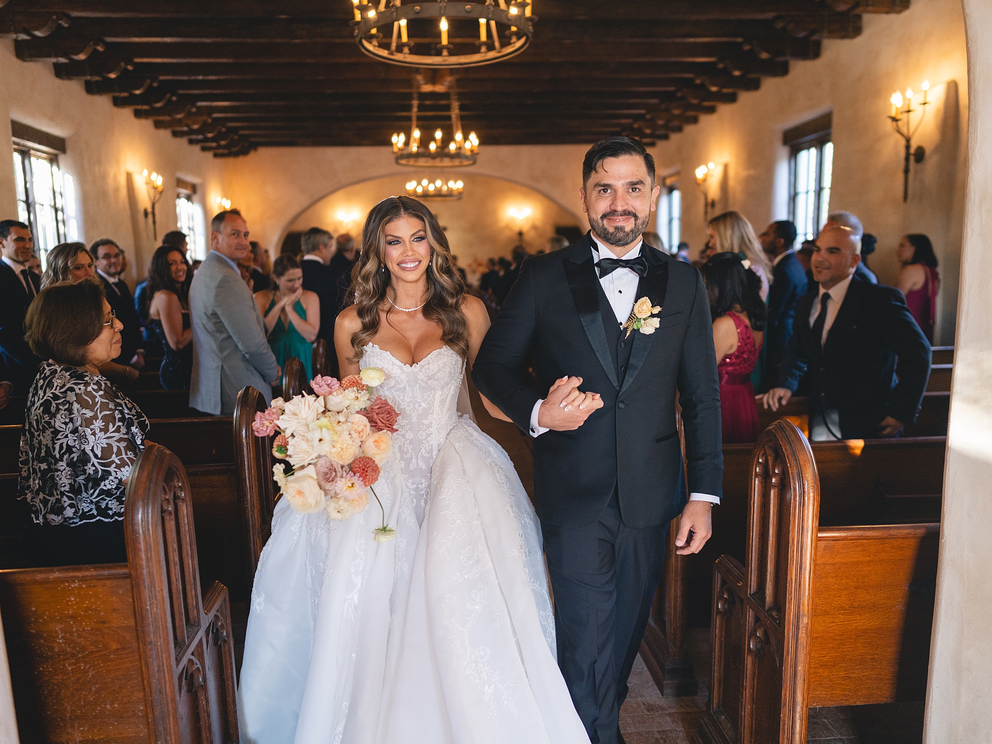 ceremony at San Antonio venue with guests seated, rustic ceremony backdrop