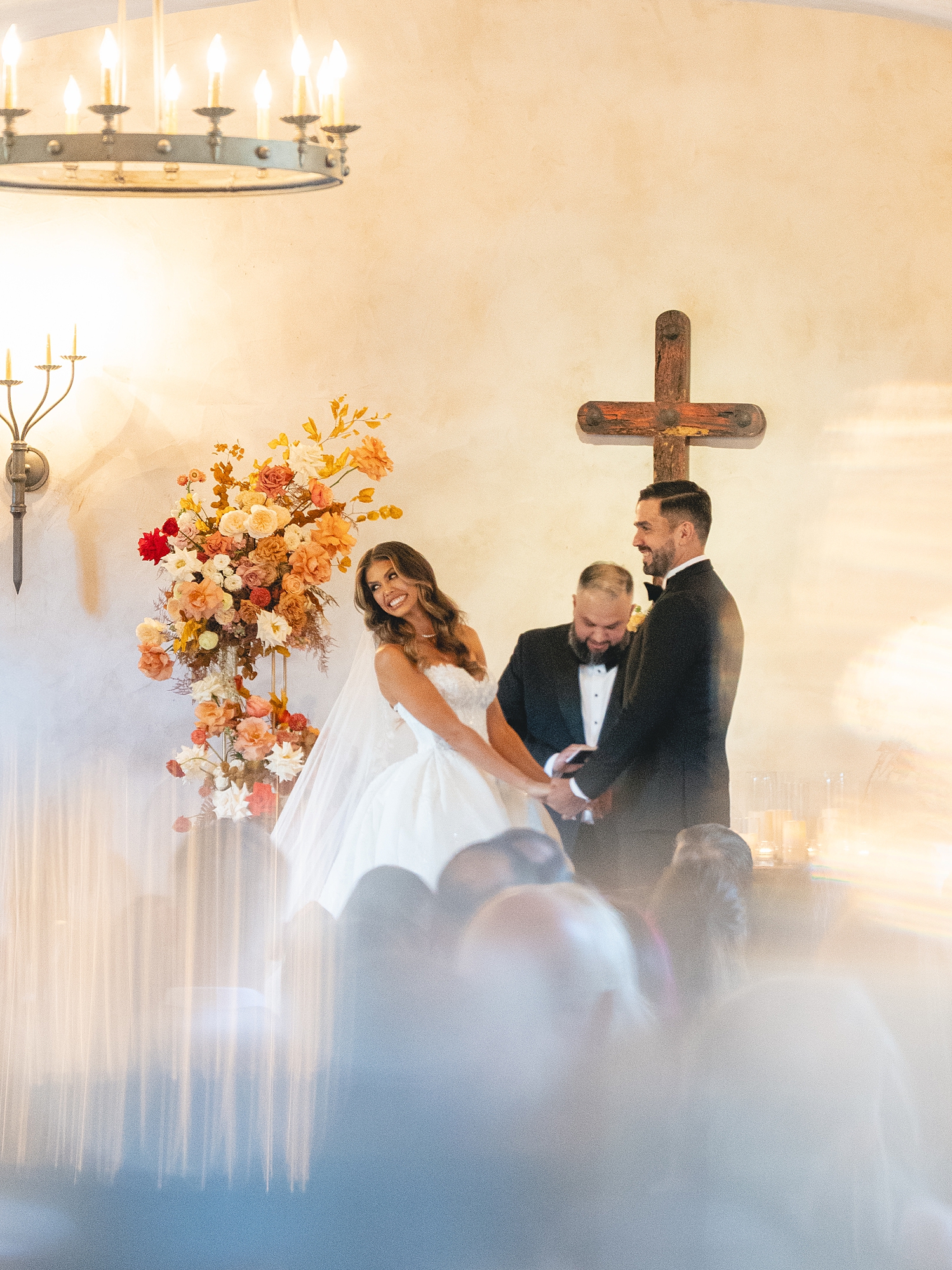 ceremony at San Antonio venue with guests seated, rustic ceremony backdrop