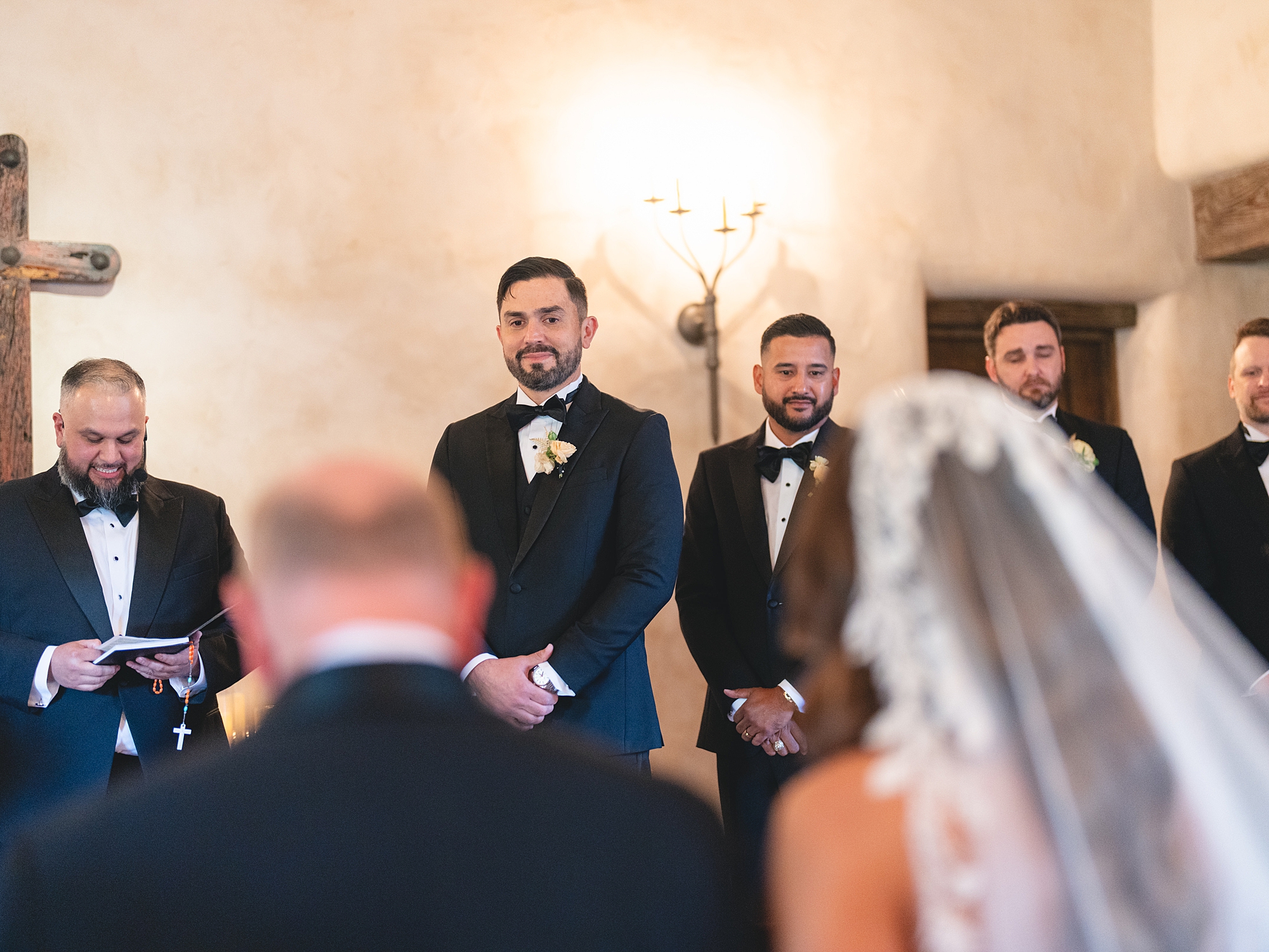 ceremony at San Antonio venue with guests seated, rustic ceremony backdrop