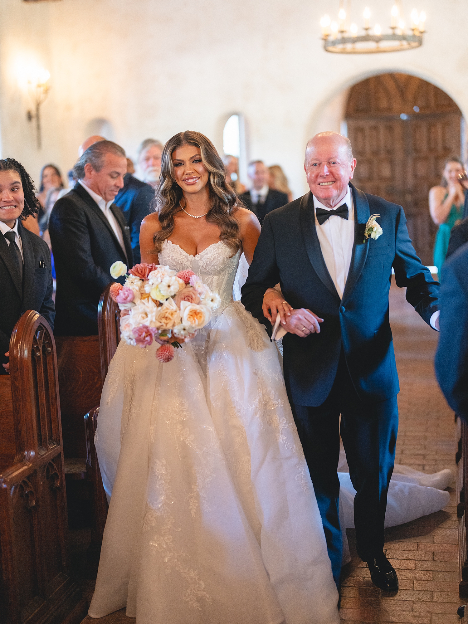 ceremony at San Antonio venue with guests seated, rustic ceremony backdrop