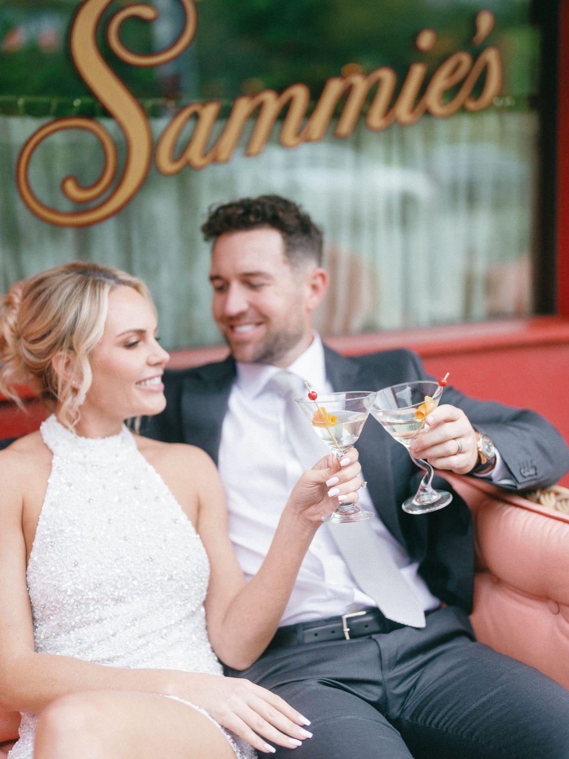 bride and groom chic and moody austin engagement photos drinking martinis