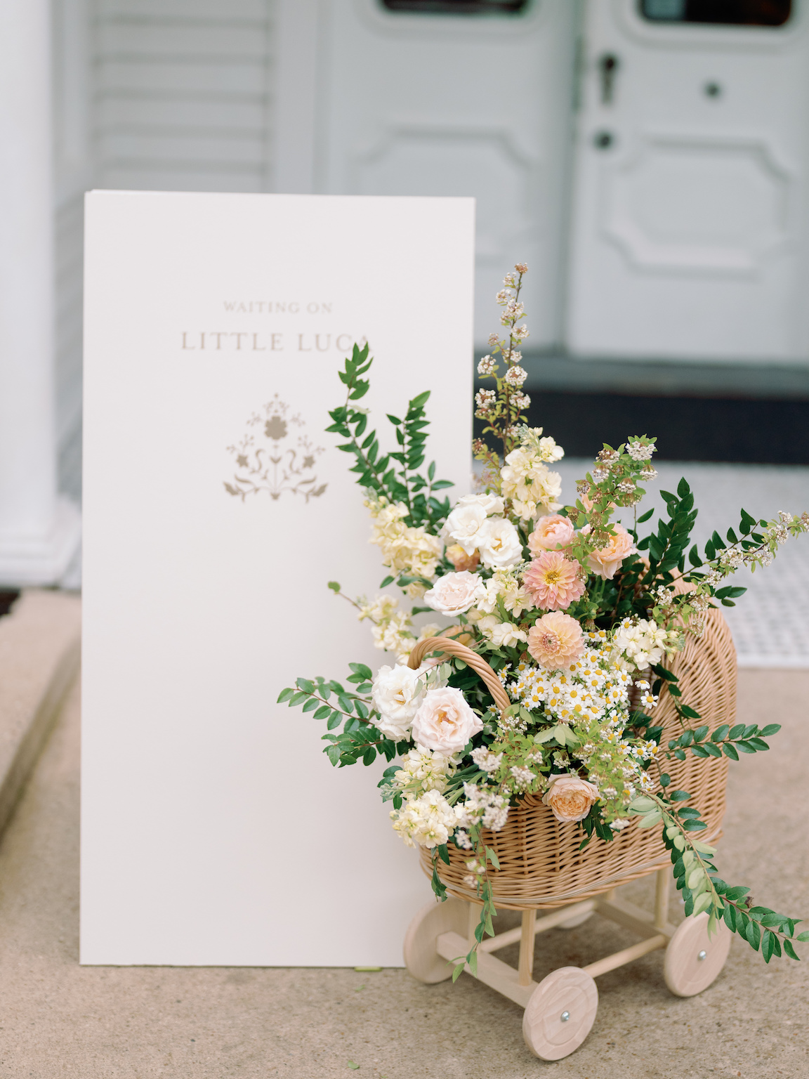 Downtown Austin Baby Shower welcome sign and floral arrangement