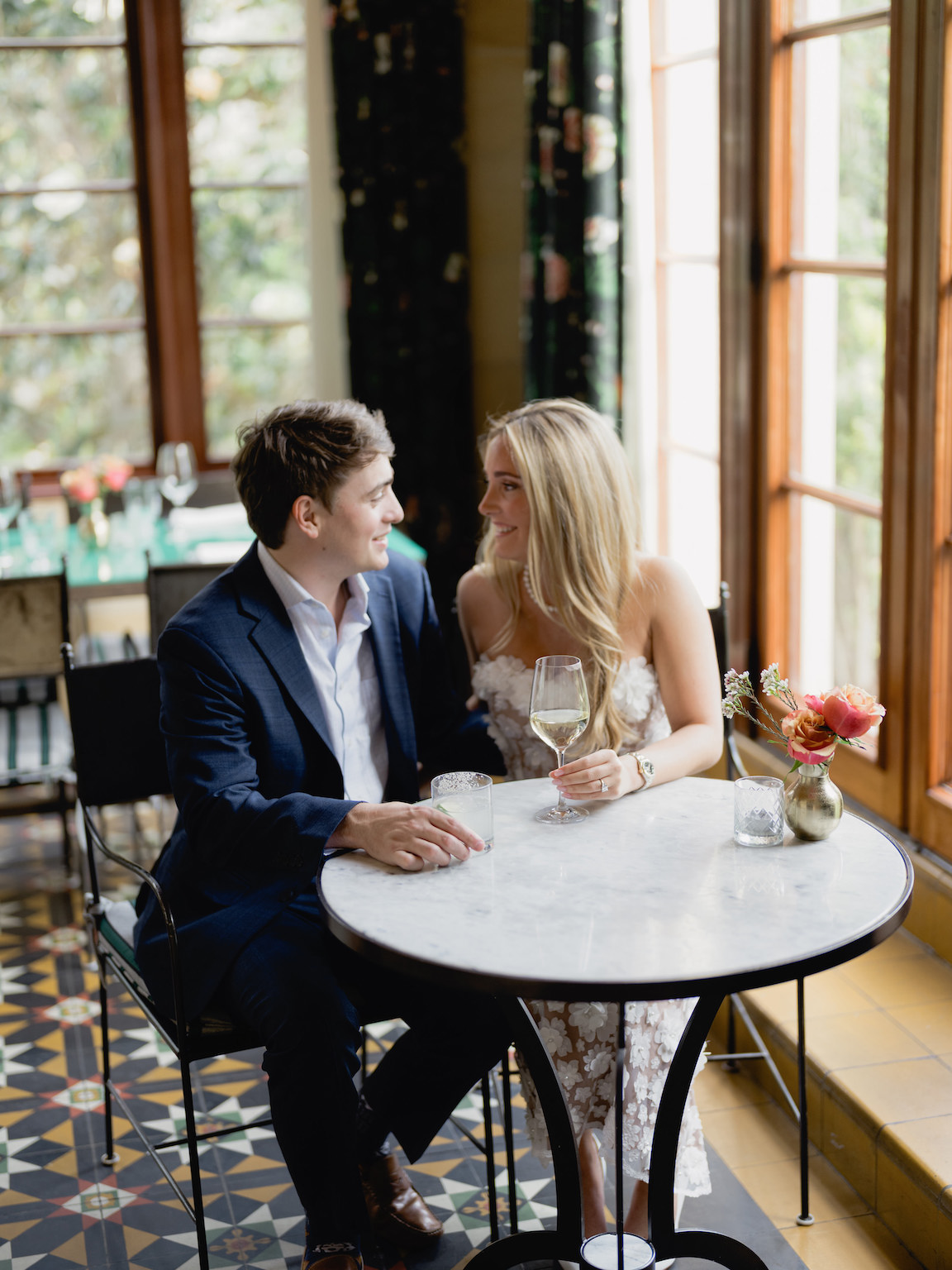 Elegant indoor portrait of engaged couple sitting at the vintage bar at Commodore Perry Estate in Austin