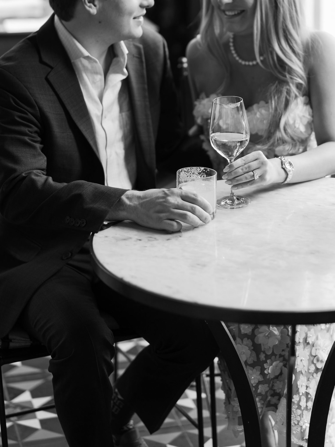 Elegant indoor portrait of engaged couple sitting at the vintage bar at Commodore Perry Estate in Austin