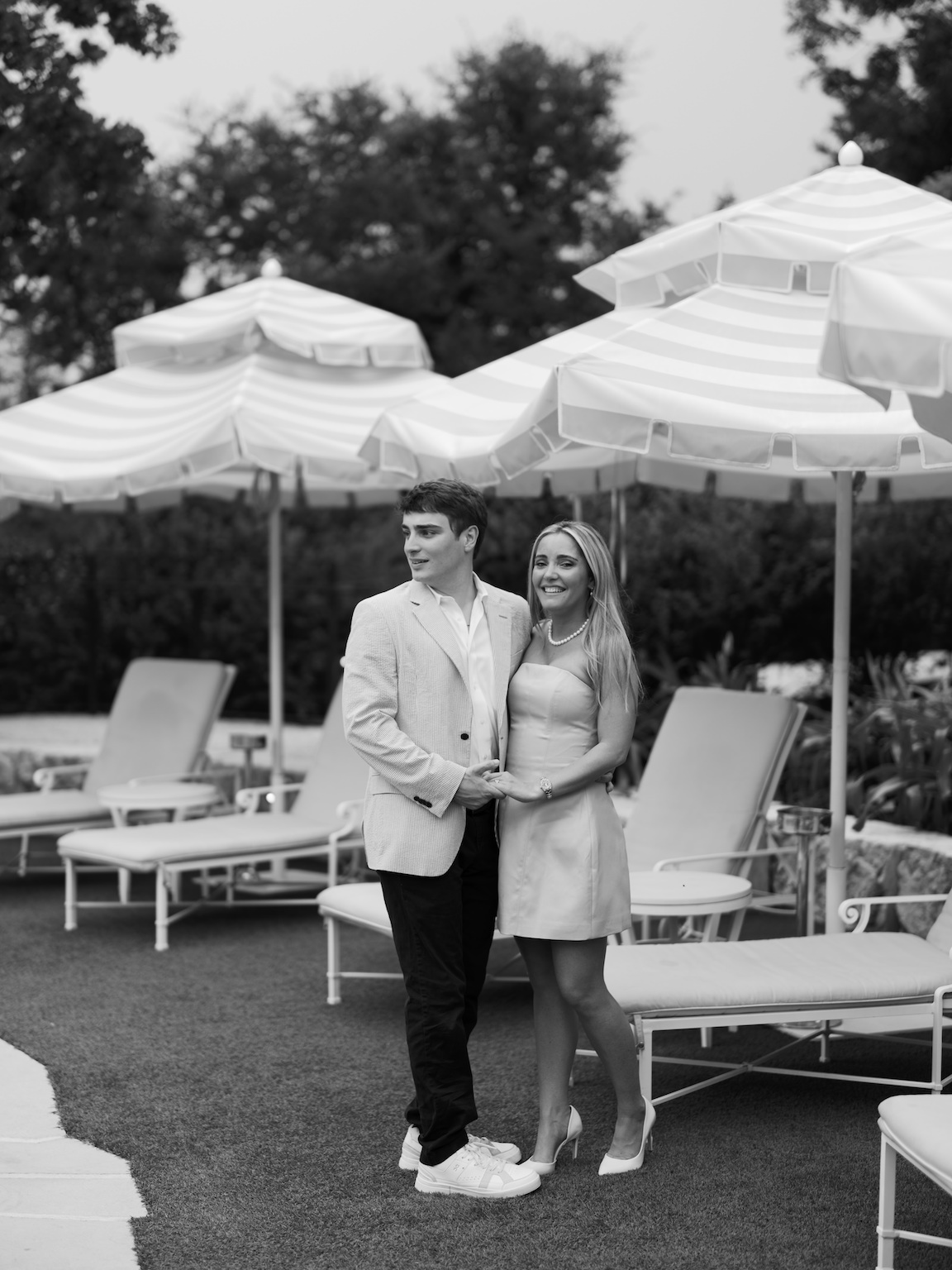 Romantic engagement photo of couple standing by the pool at Commodore Perry Estate
