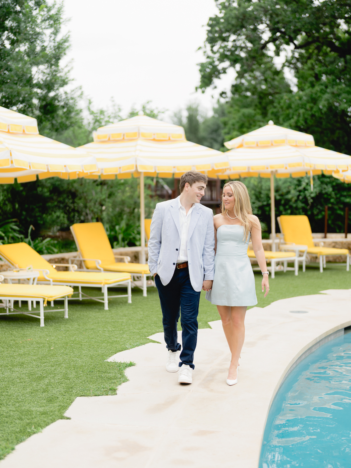 Romantic engagement photo of couple standing by the pool at Commodore Perry Estate