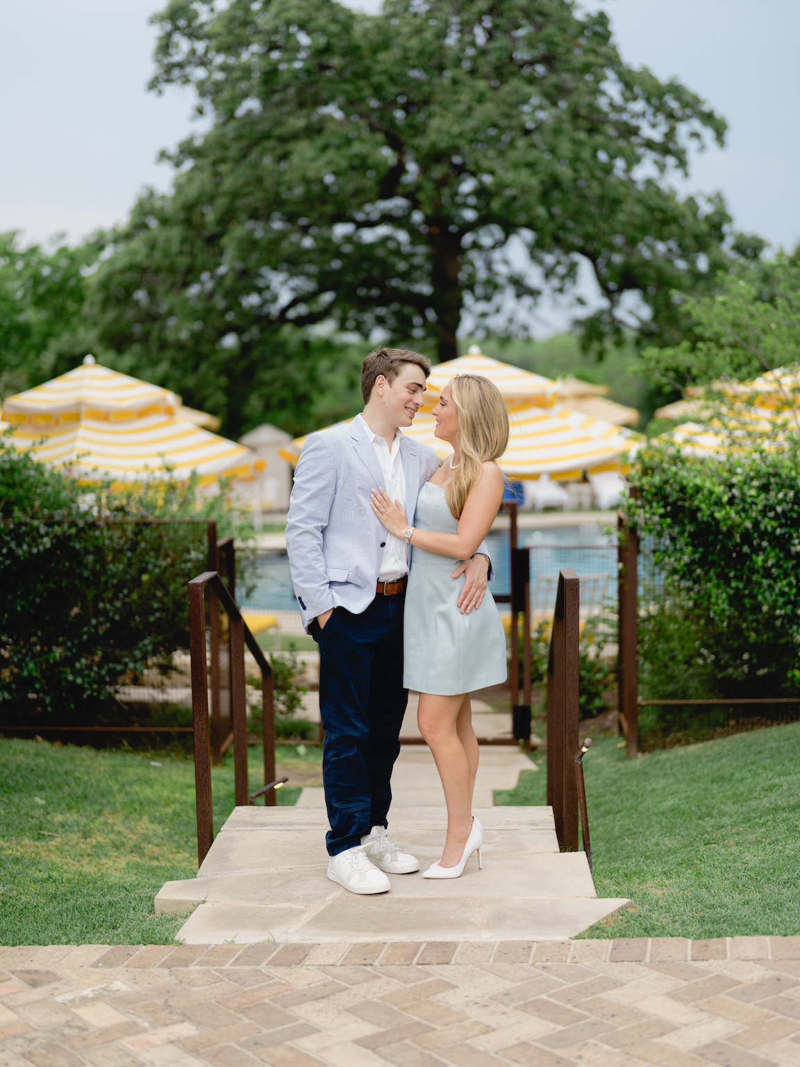 Romantic engagement photo of couple standing by the pool at Commodore Perry Estate
