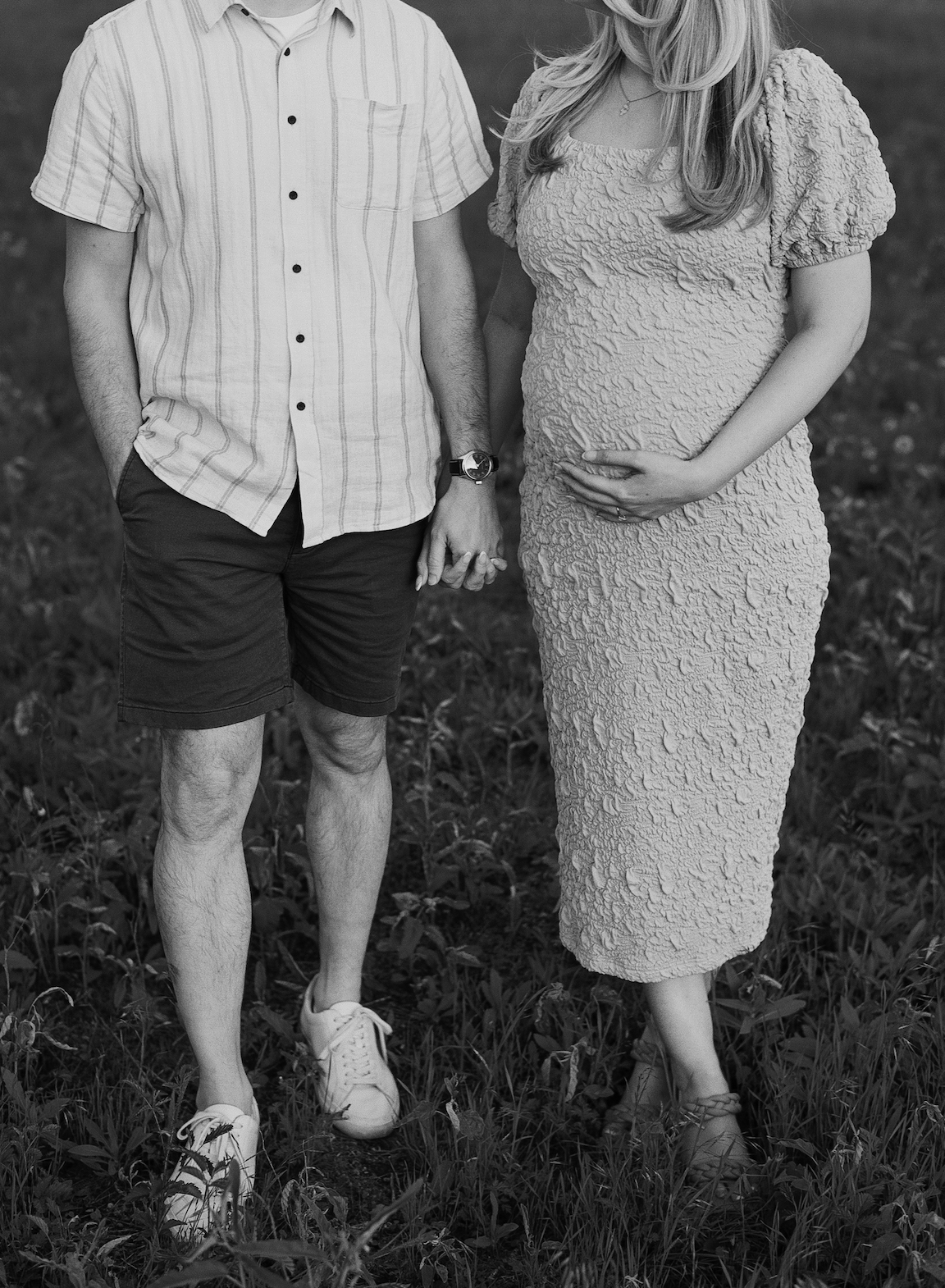 Chelsea and Clayton during their film maternity photos in a sun-drenched Austin park, surrounded by greenery