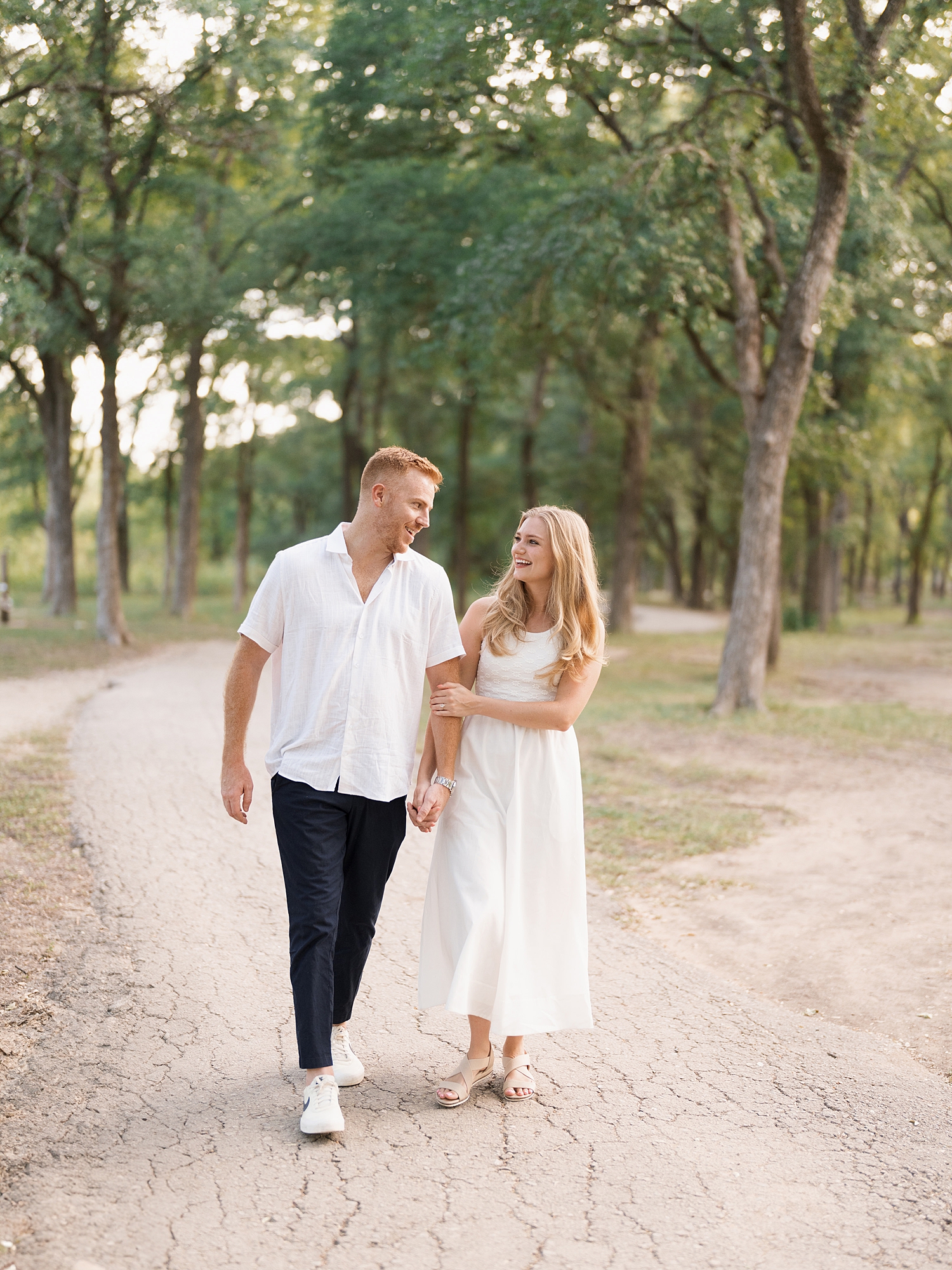 couple walking at McKinney Falls engagement
