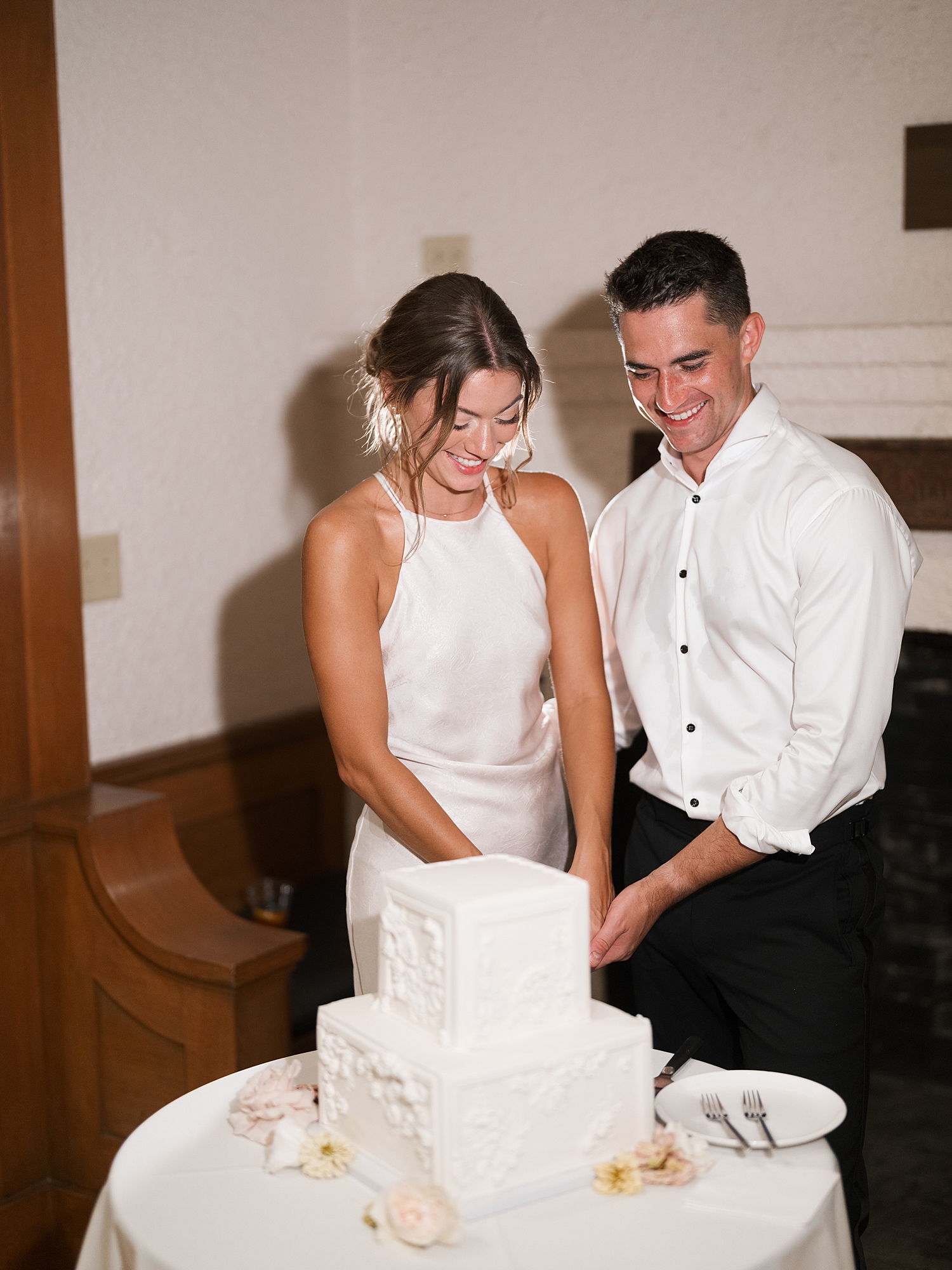bride and groom cutting cake at laguna gloria austin wedding venue