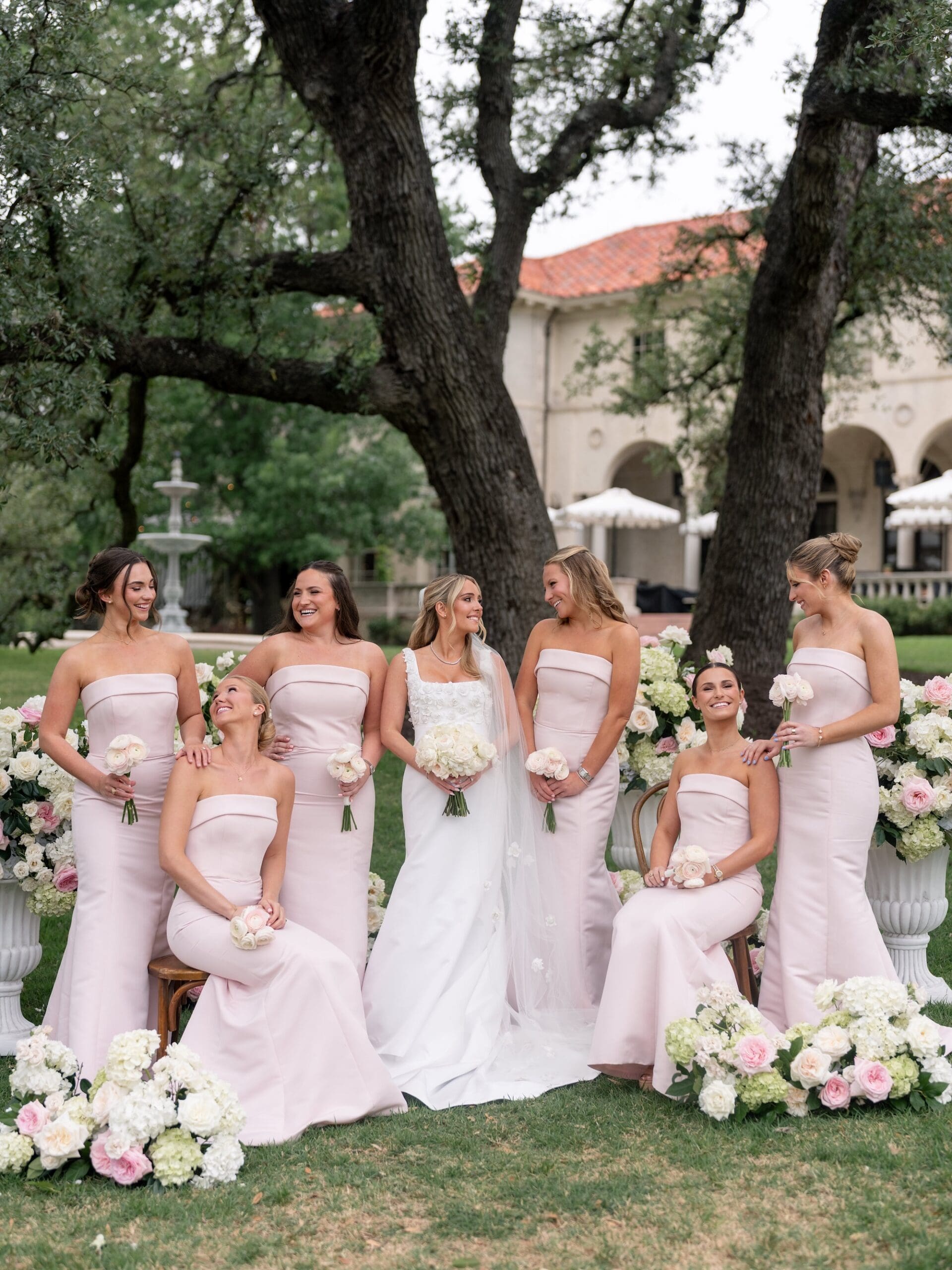 Bride and groom celebrating with their wedding party during a luxury Commodore Perry Estate wedding in Austin, Texas.